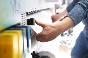 man working on industrial color printing