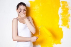 women blocking nose with paint smell