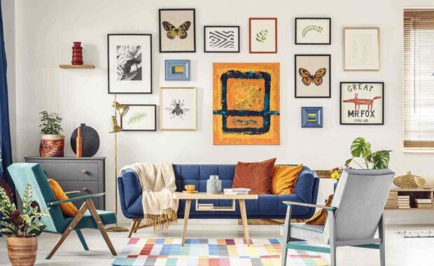 posters gallery hanging on the wall in bright living room interior with blue sofa