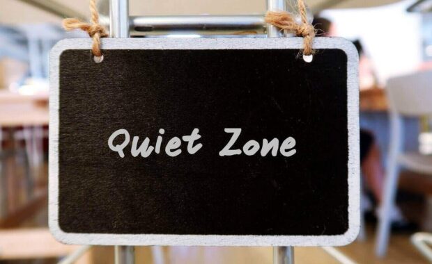 chalkboard hanging in coworking space with text handwritten quiet zone