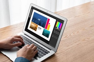 man designing graphics on laptop