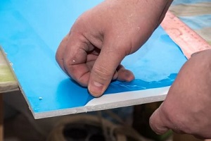 man applying protective film