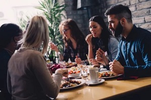 friends eating in the restaurant with acoustic art panels