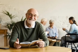 smiling senior man reading book