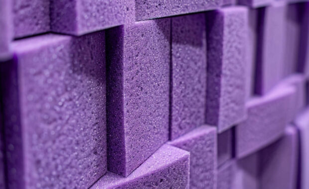 zoomed-in detail of interlocking lilac acoustic wall art foam pieces on a studio wall