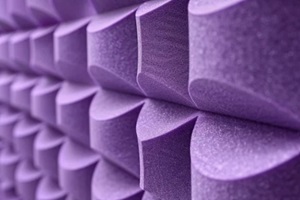 zoomed-in detail of interlocking lilac acoustic foam pieces on a studio wall