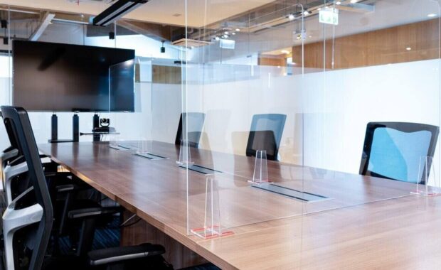 blank display in video conference meeting room with clear acrylic sheet separates the center on the conference table