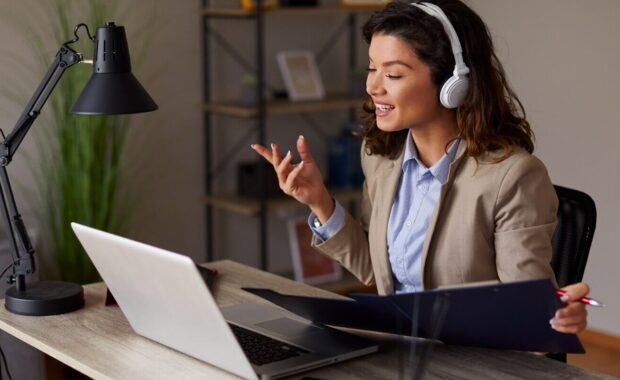 young woman has a business conference via laptop - custom wall covering - digital wall covering