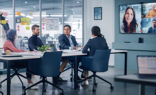 businesspeople do video conference call with big wall tv