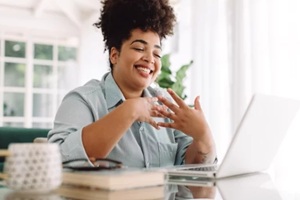 businesswoman at home video calling on laptop