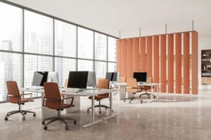 modern office interior with desks, computers, glass walls and orange partitions, minimalist architecture on a bright concrete background